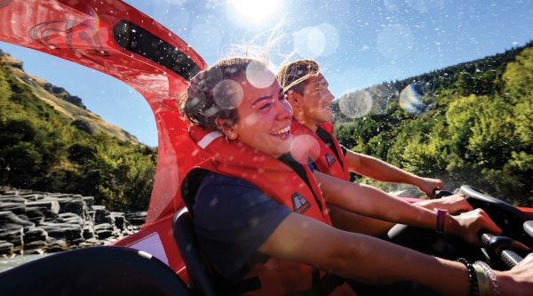 Two visitors enjoying the ride on Shotover Jet